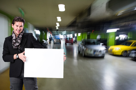 Picture of smiling handsome man with big blank boardの写真素材