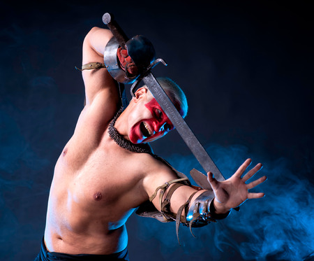 Brave knight with a sword on a dark backgroundの写真素材