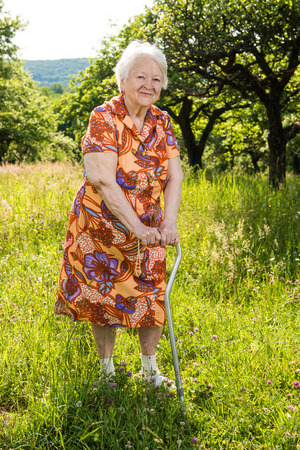 Beautiful smiling old woman on natural backgroundの写真素材