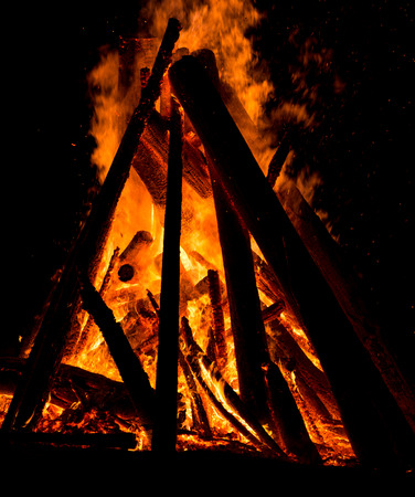 Big bonfire against dark night sky. Fire flames on black backgroundの写真素材