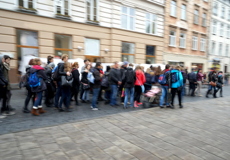 Busy city people going along the street. Intentional motion blur
