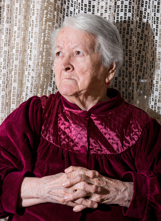 Angry old senior woman at homeの写真素材