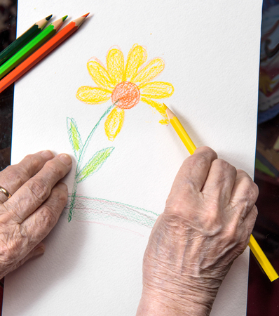 Old woman painting  flowerの写真素材