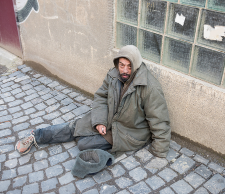 Homeless man on the street of the cityの写真素材