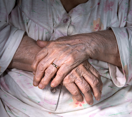 Close-up of old womans wrinkled  handsの写真素材
