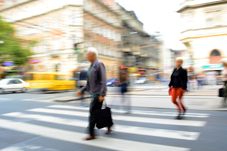 Busy city street people on zebra crossing. Intentional motion blur