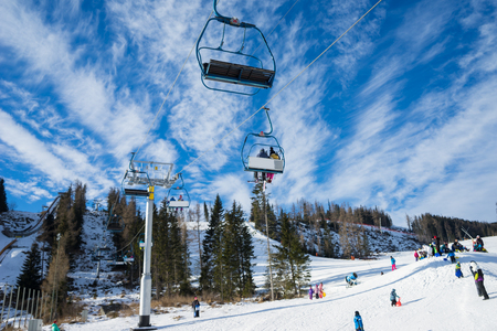 HIGH TATRAS, STRBSKE PLESO,SLOVAKIA - JANUARY 03, 2016: Winter mountains panorama with ski slopes and ski liftsのeditorial素材