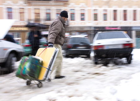 Poor man pulling a cart in the city. Intentional motion blurの写真素材