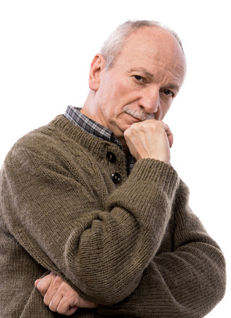 Portrait of a senior thoughtful man in posing on a white; backgroundの写真素材