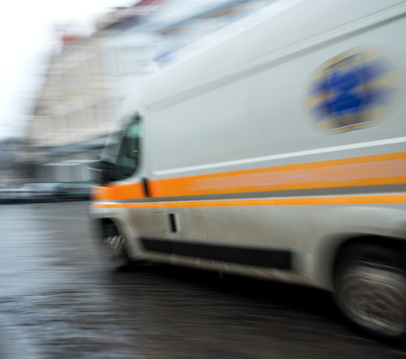 Ambulance in motion driving down the road. Intentional motion blurの写真素材