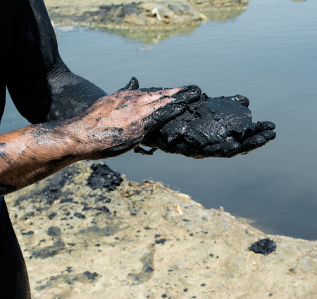Man applying black healing clay at the spa resort
