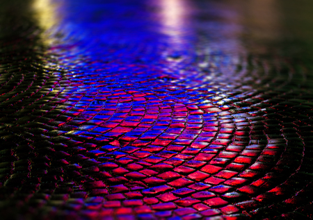 Abstract urban background. Streets after rain with reflections of light on wet roadway. Pavement textureの写真素材