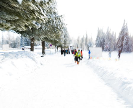 View of skiers at ski resort in motion blur. Blurred ski resort background