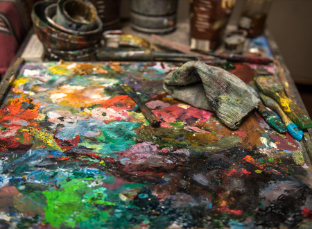 Artistic palette knife on an old wooden paletteの写真素材