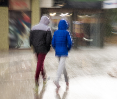 People walking down the street on rainy day. Intentional motion blurの写真素材