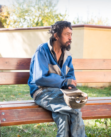 Homeless man on the street of the city. Senior beggarの写真素材