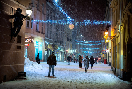 UZHHOROD, UKRAINE - 15 January, 2019: View of the city covered with snow at night in Uzhhorod, Ukraine. Korzo is the central street of the cityのeditorial素材