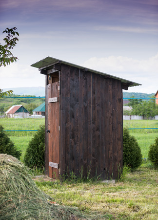 Dry wooden outdoor toilet on the backyardの写真素材
