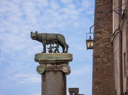 ROME, ITALY - MAY 3, 2019: The bronze statue of the Capitoline Wolf (Lupa Capitolina) feeding Romulus (founder of Rome) and Remus against  blue sky in Rome, Italyのeditorial素材