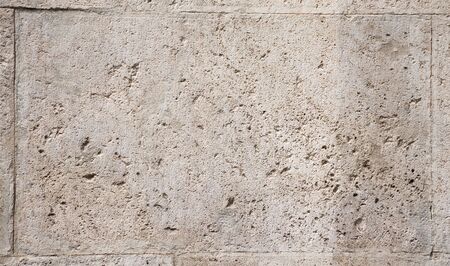 Background of fragment of old Roman stone wall,  natural color texture on a sunny day