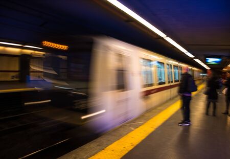 Abstract silhoettes of passengers in subway. Intentional motion blur. Defocused image