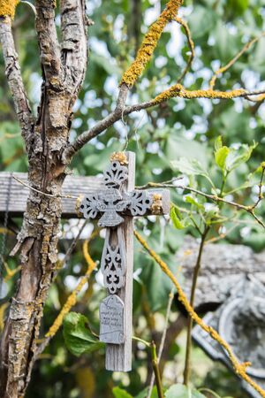 SIAULIAI, LITHUANIA - JULY 28, 2019:A large number of wooden crosses and crucifixes at the Hill of Crosses. Ð¢ext on the crosses in different languages - O God, protect our family, give healthのeditorial素材