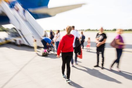 The blurred image of passengers walking to board the airplane. Defocused image, intentional motion blurの写真素材