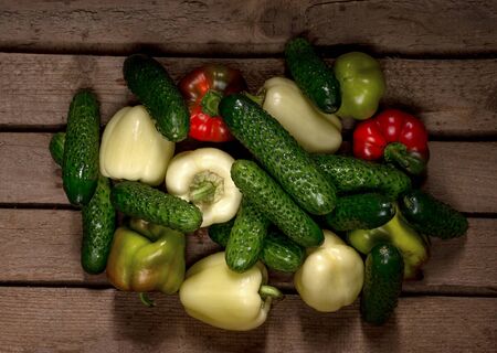 Fresh Organic Cucumbers and Peppers on a wooden backgroundの写真素材
