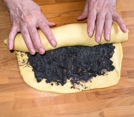 Preparition of homemade roll with poppy seedsの写真素材