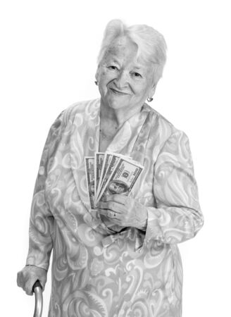 Portrait of old woman with a cane and holding money in hand on a white backgroundの写真素材