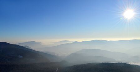 Winter Carpathian mountains on a bright sunny day. Winter snow covered mountain peaks