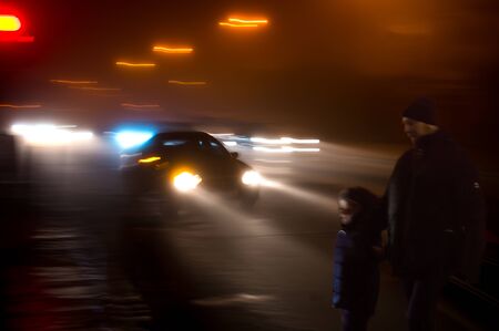 Dangerous situation on zebra crossing at night. Intentional motion blur