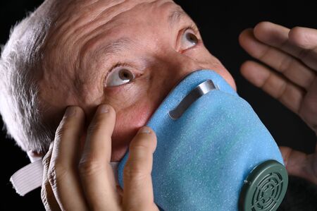 Healthcare and medicine concept. Sick old man posing in mask s over black backgroundの写真素材