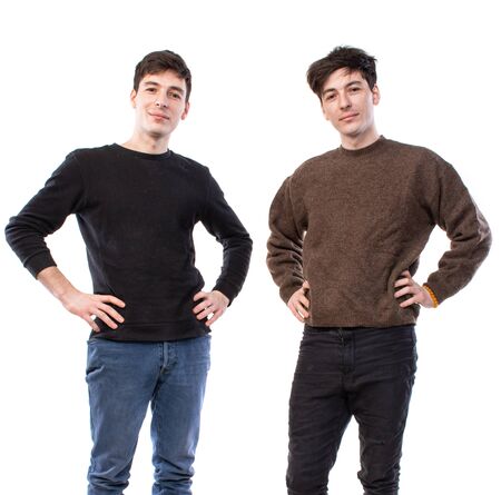 Two handsome young men posing on a white background. Twin brothersの写真素材