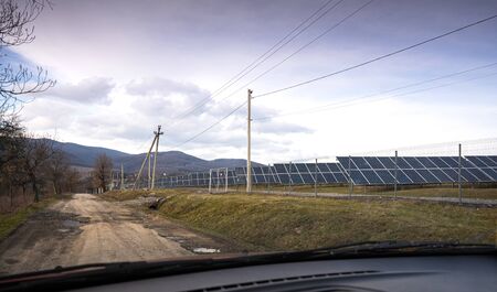 View of a solar energy station on a field. Solar panel, photovoltaic, alternative electricity sourceの写真素材