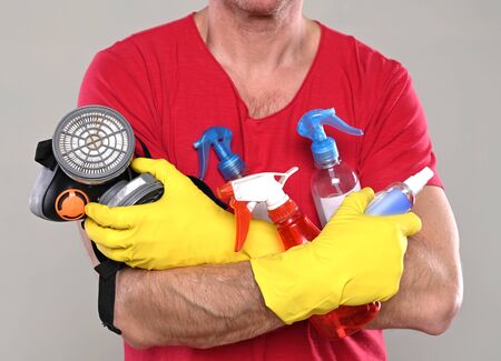 Healthcare and medical concept. Man in  gloves  holding disinfecting liquid  for cleaning hands and...