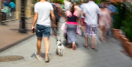 Busy city people going along the street. Intentional motion blur. Defocused imageの写真素材