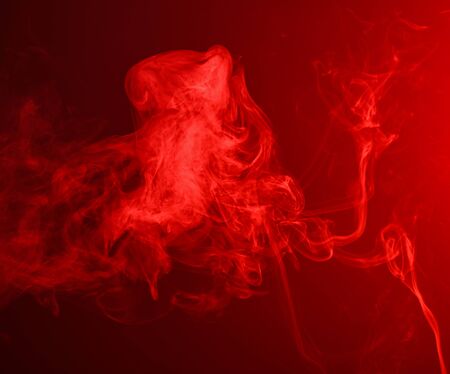 Red smoke over black background