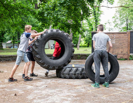 UZHHOROD, UKRAINE - MAY 10, 2020: Ð¡hildren build a pyramid from old tires on the playground in Uzhhorod, Ukraineのeditorial素材
