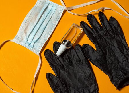 Protective equipment for prevention of virus infections, COVId-19. Hand sanitizer, surgical mask and latex glovesの写真素材
