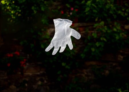 Disposable plastic glove flies in the air during a coronavirus epidemicの写真素材
