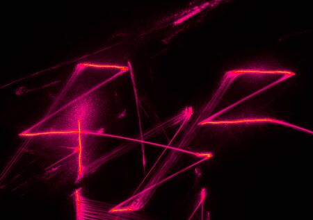 Abstract pink lines drawn by light on a black background. Laser lines