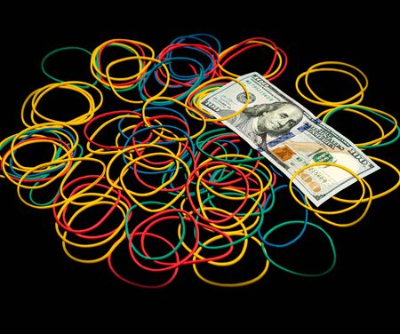 Colored rubber bands for money and 100 dollar banknote on a black background