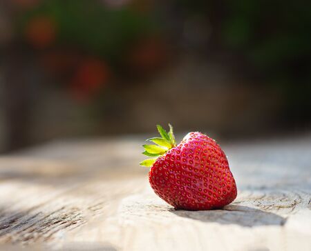 Fresh organic strawberry on an old wooden backgroundの写真素材