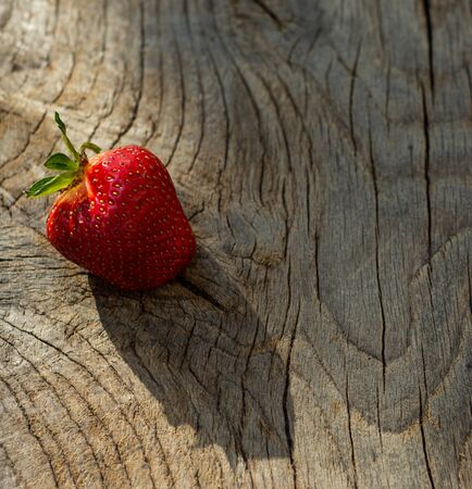 Fresh organic strawberry on an old wooden backgroundの写真素材