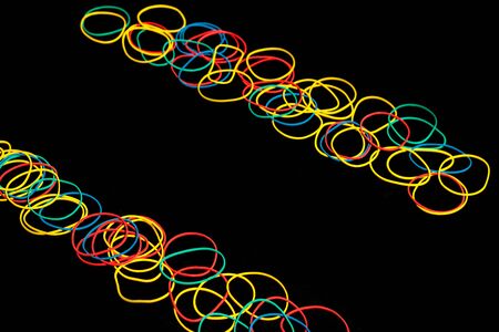 Colored rubber bands for money on a black backgroundの写真素材