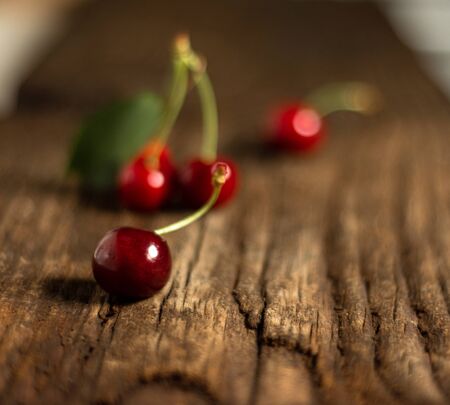 Organic fresh cherries on wet wooden backgroundの写真素材
