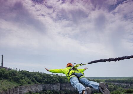 Rope jumping. Man jumping from the bridgeの写真素材