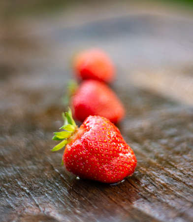 Fresh organic strawberries on an old wooden backgroundの写真素材