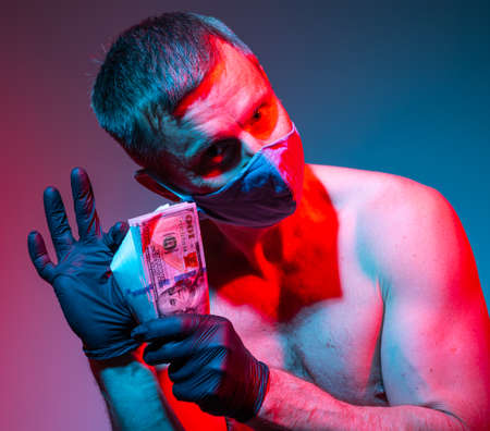 Handsome man in protective gloves and face mask holding dollar cash money